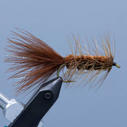 Woolly Bugger fly with brown marabou tail and olive body on a hook