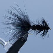 Fly streamer with black marabou tail and iridescent flash, on a hook