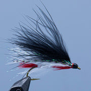 Streamlined streamer fly with dark body, white tail, red accents, and barbed hook