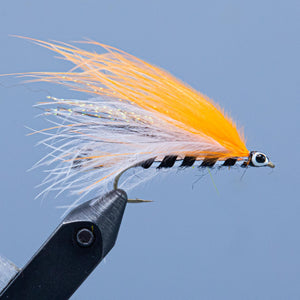 The Mansfield Marabou fishing fly is an orange and white winged streamer fishing fly with a black and silver body.  Tied for a Rangeley Maine Fly Shop