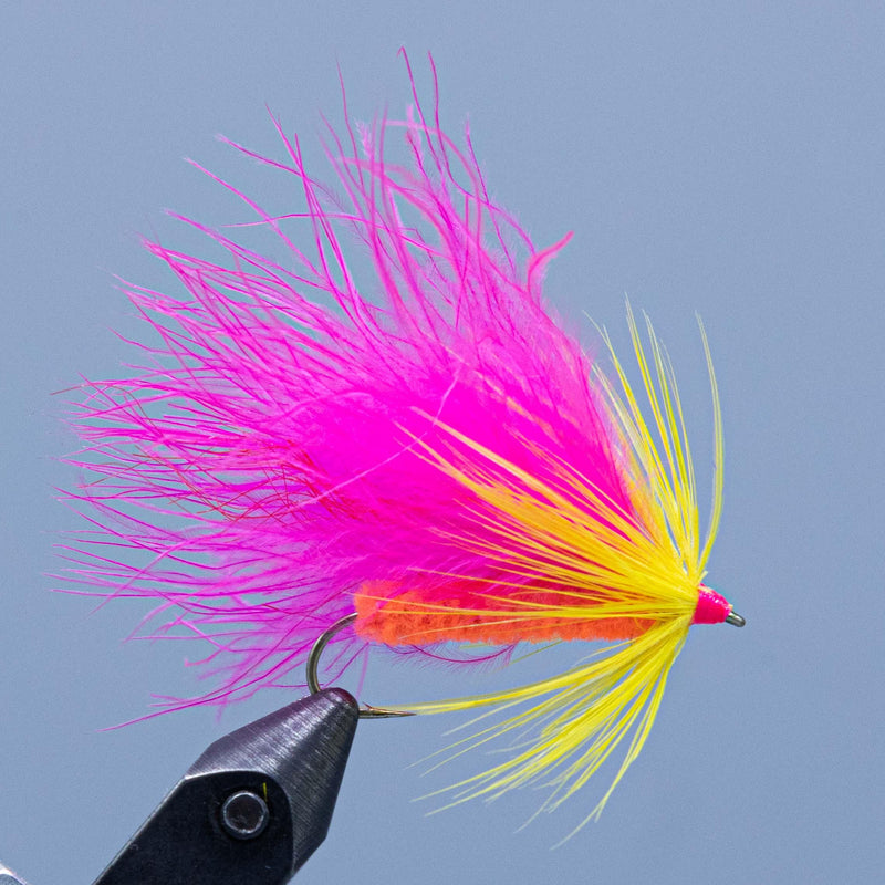 Cardinelle fishing lure with pink and yellow feather fibers on a metal hook
