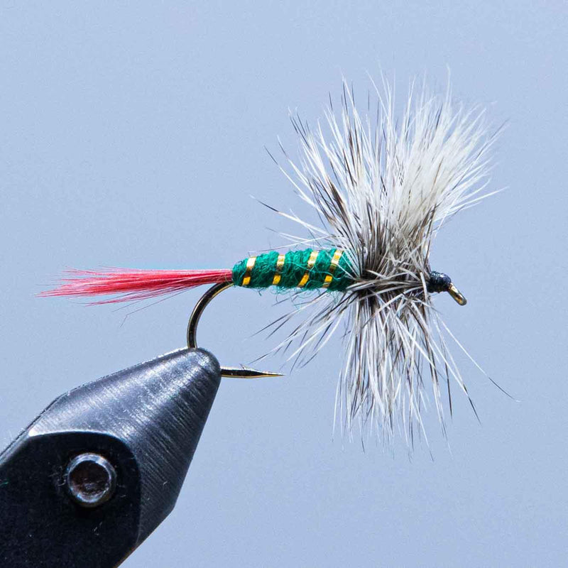 Feather fishing lure with white wing, green-and-yellow bead, red accent thread