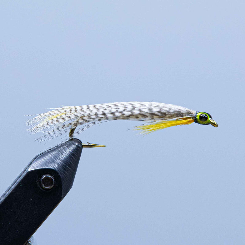 Fishing lure with white-and-black wing, yellow body, green head