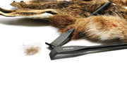 Hareline dubbing rake with dark metal head and comb, alongside brown fur