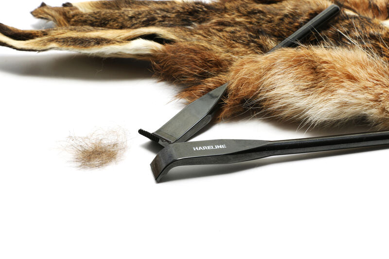 Hareline dubbing rake with dark metal head and comb, alongside brown fur