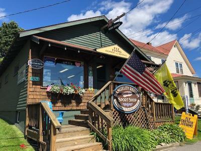 Gift certificate redemption storefront with flags, awning, and hanging sign