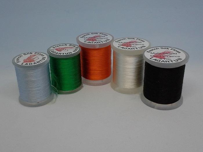 Assorted silk floss spools in black, green, orange, light gray and white