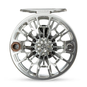 Fishing reel with silver spoked rim and copper-toned center inset