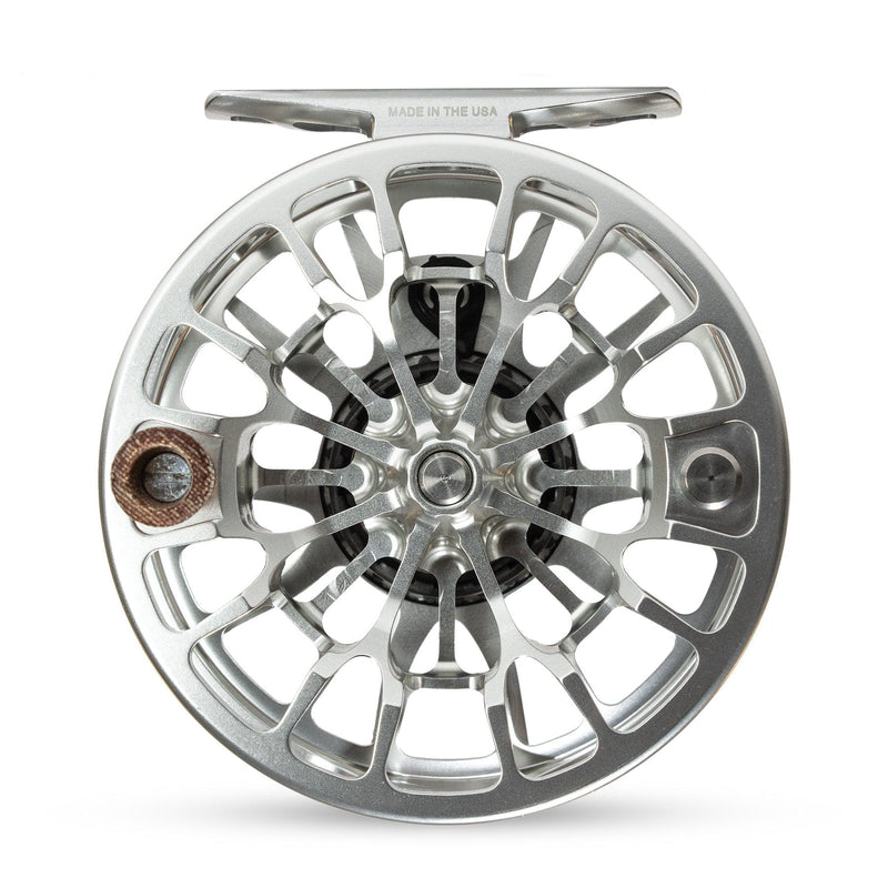 Fishing reel with silver spoked rim and copper-toned center inset