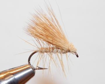 Deer hair caddis fly with tan hair wing and slim body, curved hook