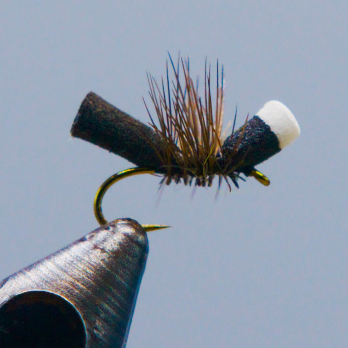 Foam ant fishing fly with dark foam body and spiky legs
