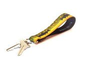 Key fob with yellow and dark patterned strap and gold keyring, keys attached