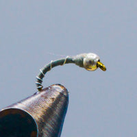 a nymph fishing fly called a gray zebra midge