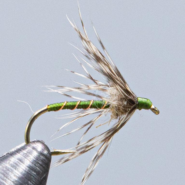 Fishing fly with green body, partridge-feather wing and hook