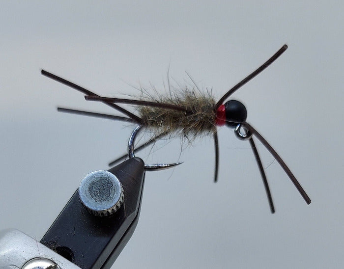 Heavy Pat's Jig fishing jig with dark head, gray hair, and multiple barbed hooks