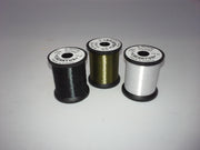 Black thread spool with winding and circular label