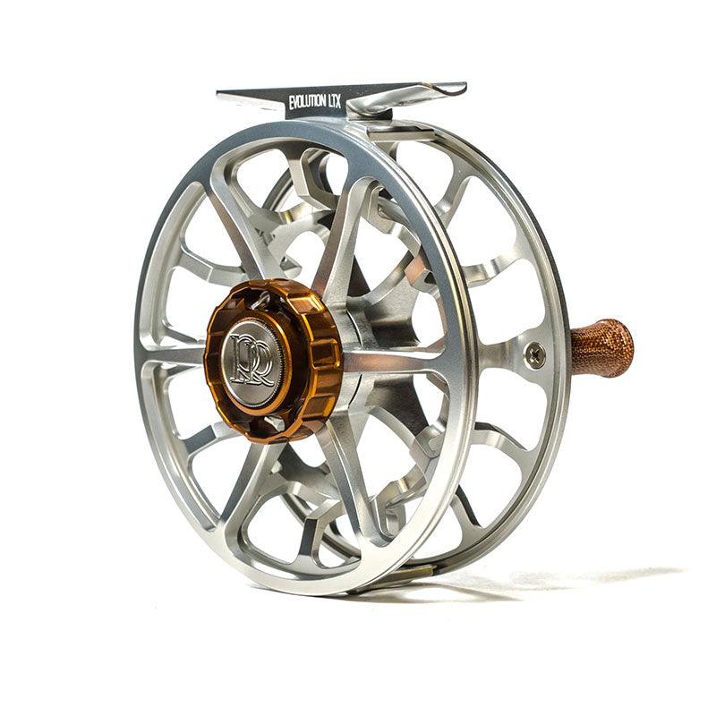 Fishing reel, silver frame with dark brown center cap and gold accents