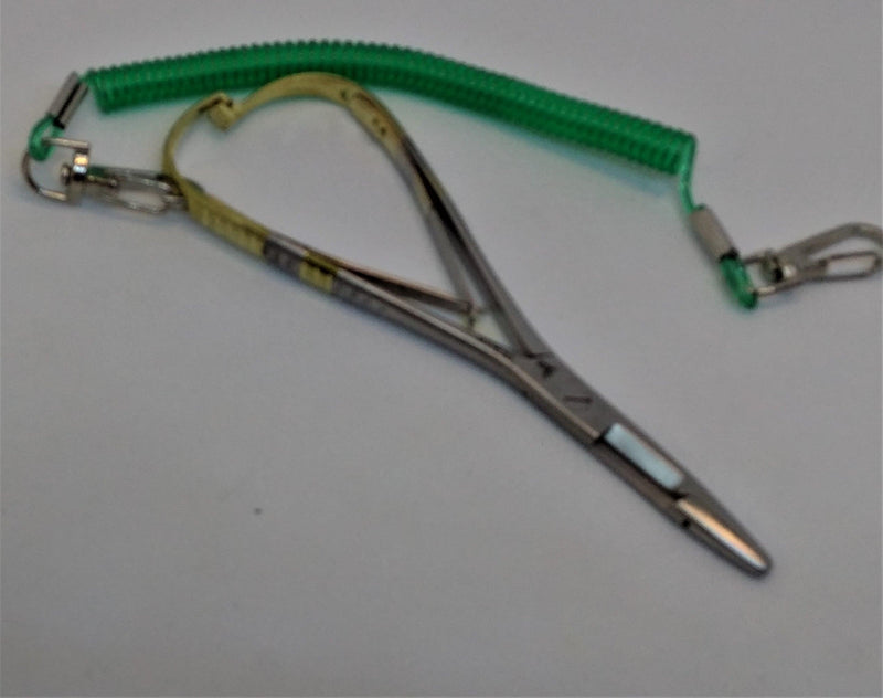 Metal scissor clamp with gold handles and green strap
