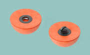 Orange foam strike indicators with black mounting bases, two round domes