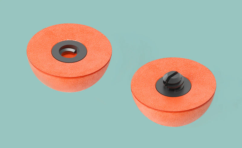 Orange foam strike indicators with black mounting bases, two round domes