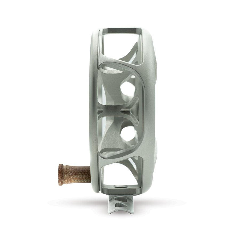 Matte platinum fishing reel side view with silver frame and brown handle