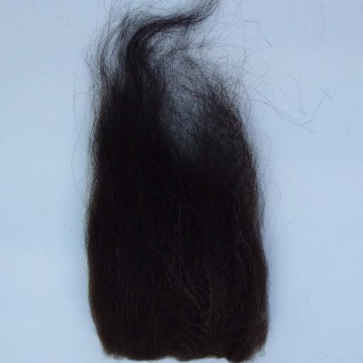 Streamer hair extension with dark, wavy-curly hair strands