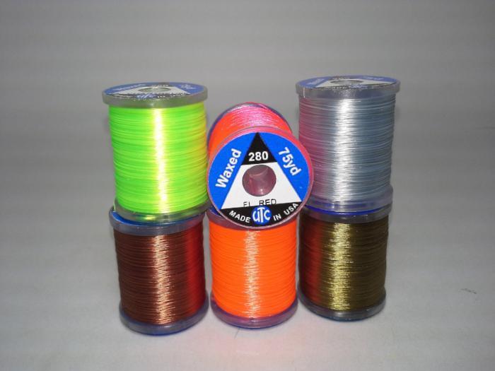 Assorted 280-denier thread spools in green, brown, orange, gray and gold