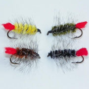 Set of four feather fishing fly lures with red tails and varied colored fuzzy bodies